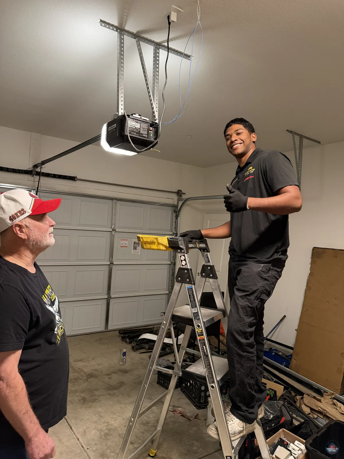 A Garage Door Doctor'Z technician replacing a garage door spring