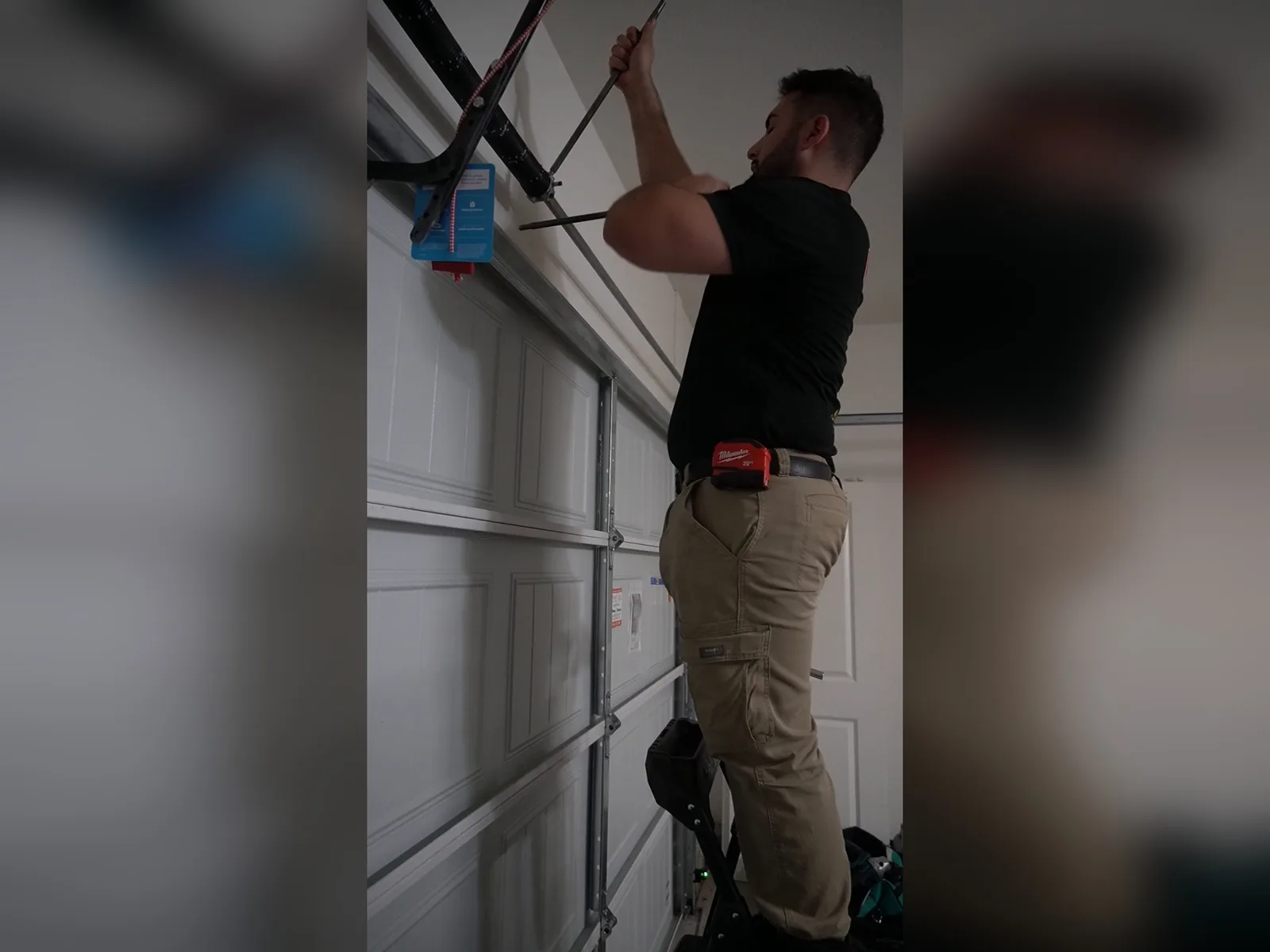Matthew adjusting garage door springs
